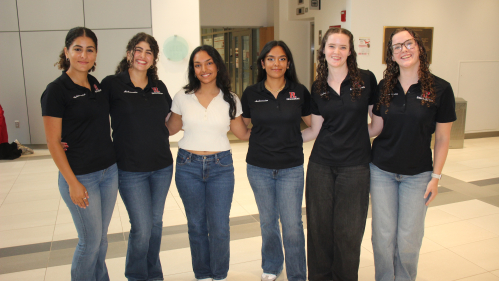 Six women students pose in a row.