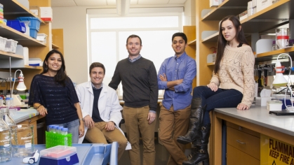 two female students and two male students with male professor posing for picture in a biomedical engineering laboratory 