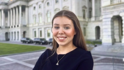 Photo of Katie Lynch standing in front of the US Capitol