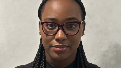 Head shot of a female college student. She is wearing glasses and her hair is braided.