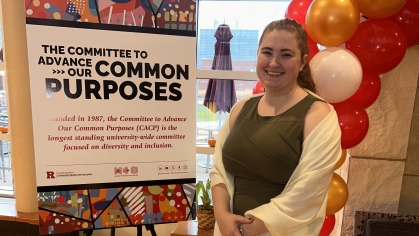 Young woman standing with her research poster.
