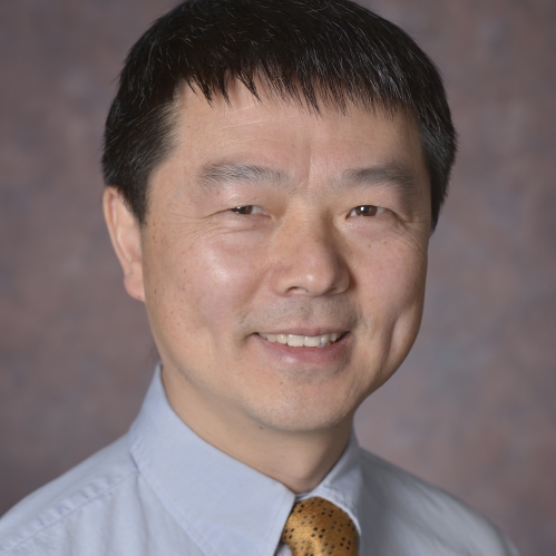 head shot of asian male with short black hair wearing a light blue shirt with a gold tie
