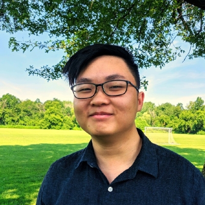 head shot of Asian young male with short black hair and eyeglasses wearing a black button down shirt