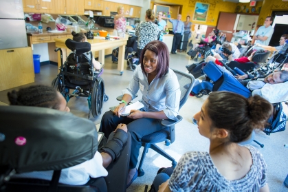 Two female college students meet with disabled people.